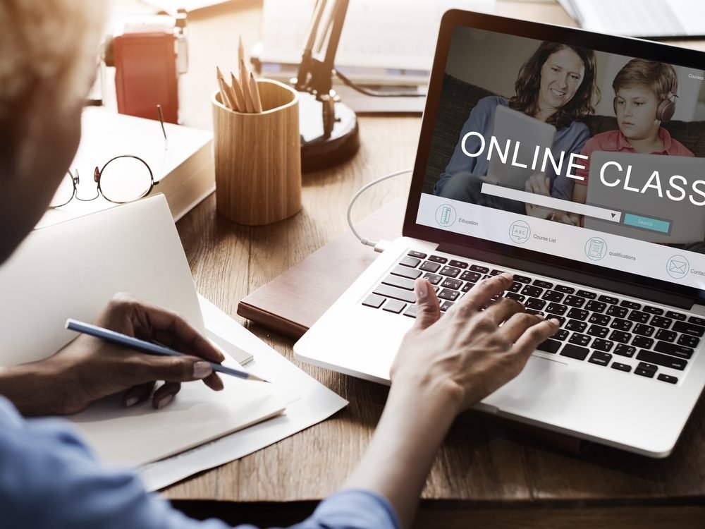 A person attending an online training class on a laptop